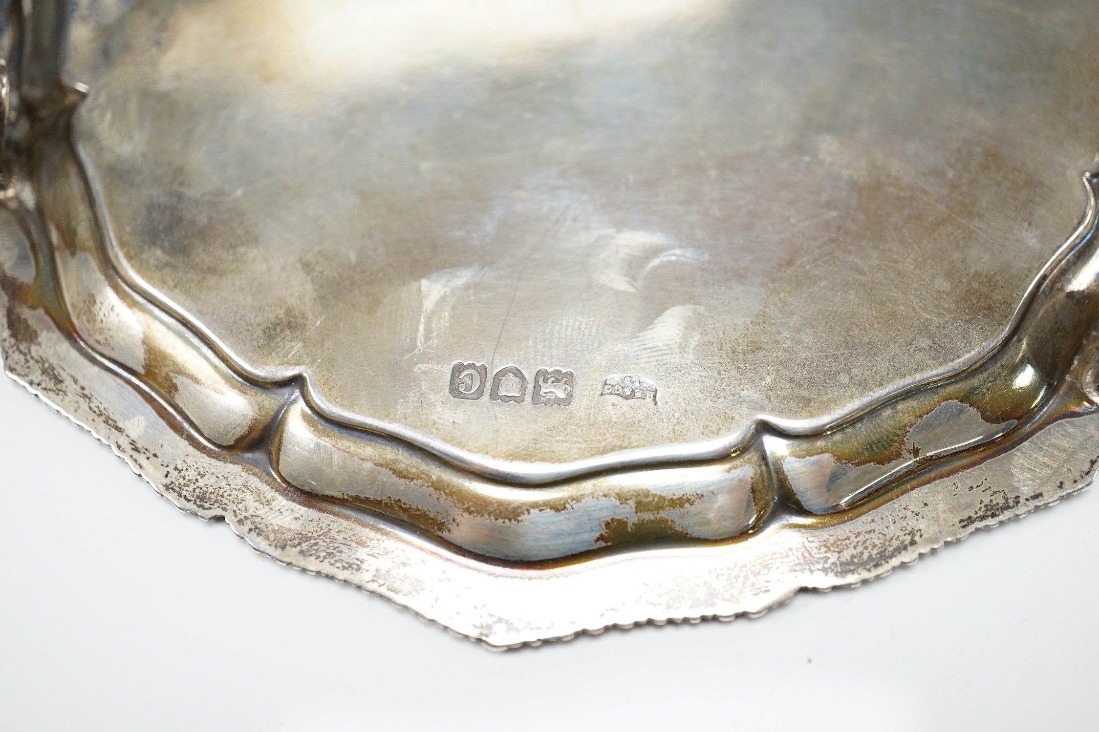 An Elizabeth II pierced silver oval fruit bowl, Poston Products Ltd, Sheffield, 1955, 28.6cm, together with a late Victorian silver waiter, London, 1898, 28.1oz.